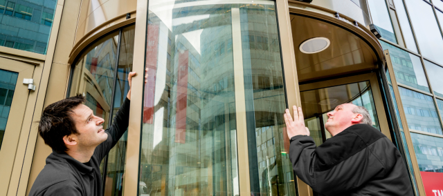 two boon edam employees installing an automatic revolving door